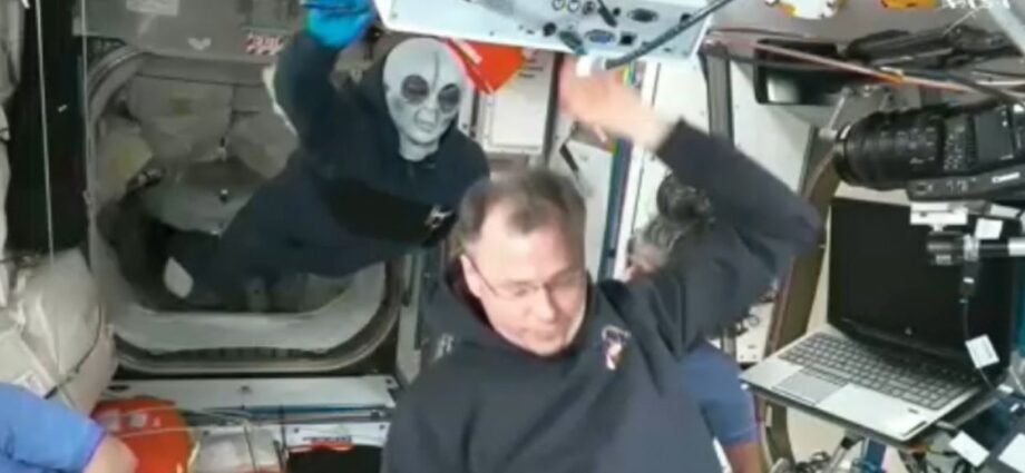 Russian cosmonaut Ivan Vagner wears alien mask while welcoming newcomers 1 alien mask 2